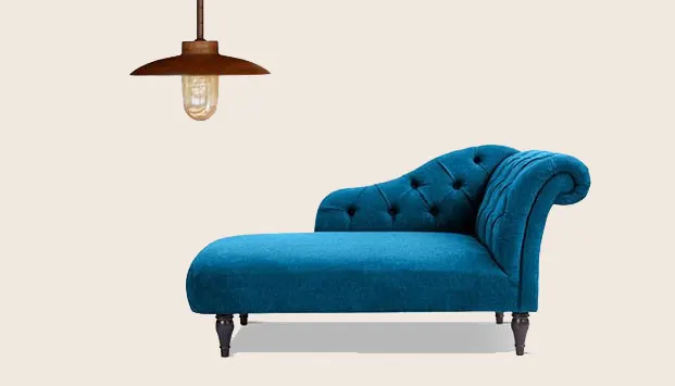 A chaise lounge sofa styled for a rustic wedding