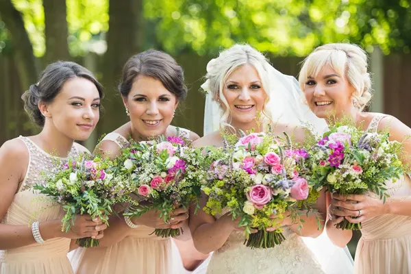 Distinctly Floral – bouquet flowers held by bride and bridesmaids